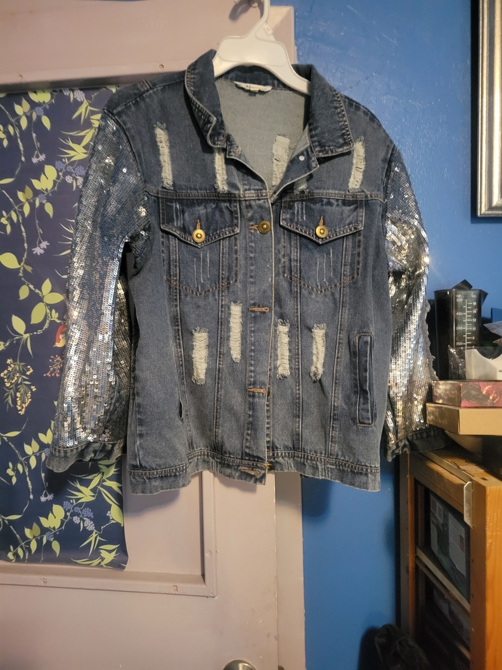Womens Distressed Denim Jacket with Silver Sequin Sleeves.